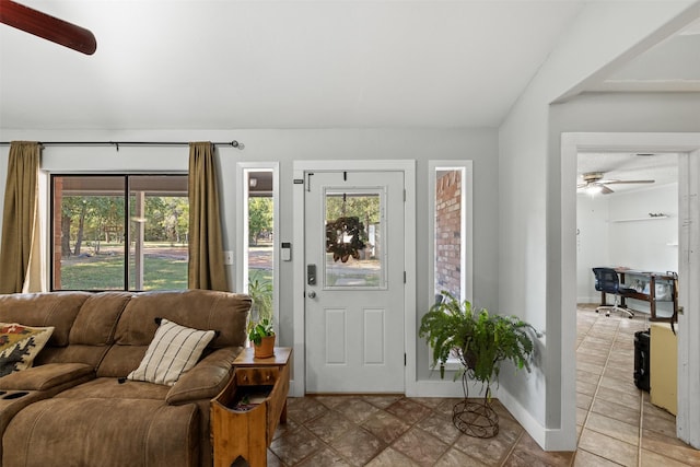 130 Green Acres Loop, Bastrop, TX 78602 - entrance foyer with light tile patterned flooring, baseboards, vaulted ceiling, and a ceiling fan