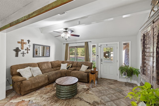 130 Green Acres Loop, Bastrop, TX 78602 - living area featuring lofted ceiling with beams, stone finish floor, baseboards, visible vents, and ceiling fan