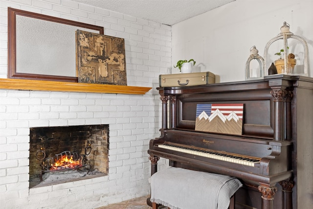 130 Green Acres Loop, Bastrop, TX 78602 - sitting room featuring a brick fireplace and a textured ceiling