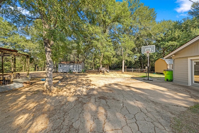 130 Green Acres Loop, Bastrop, TX 78602 - view of yard with an outbuilding and a storage shed