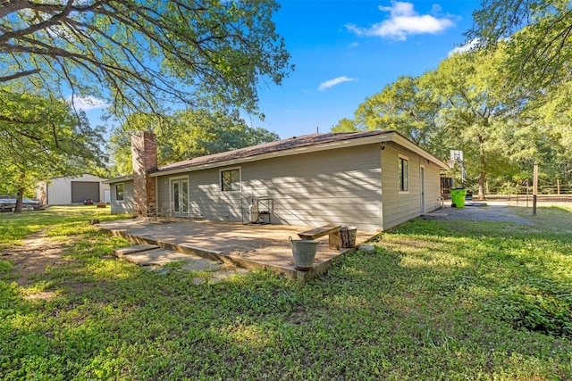130 Green Acres Loop, Bastrop, TX 78602 - back of property featuring a chimney, french doors, and a yard