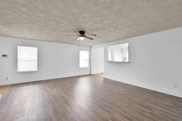 spare room featuring ceiling fan, hardwood / wood-style flooring, and a textured ceiling