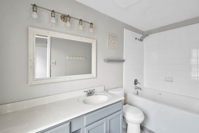 full bathroom with tiled shower / bath, toilet, and vanity