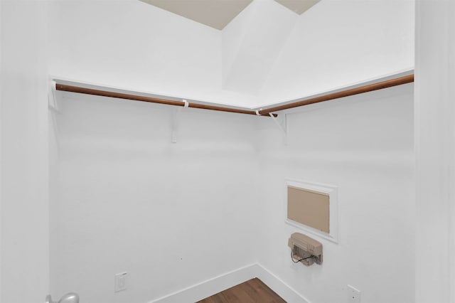 washroom with hookup for an electric dryer and hardwood / wood-style flooring