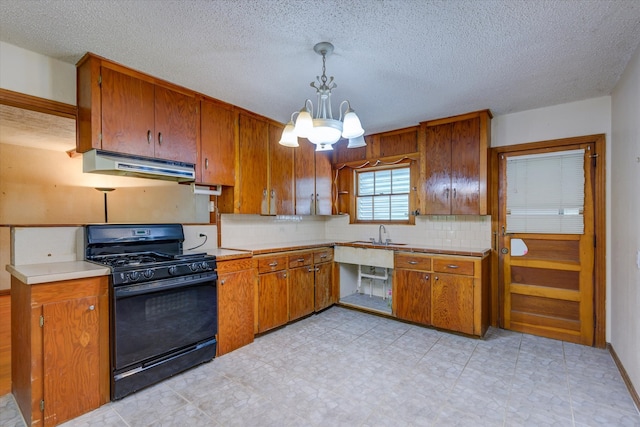 kitchen with tasteful backsplash, hanging light fixtures, gas stove, light tile patterned floors, and a notable chandelier