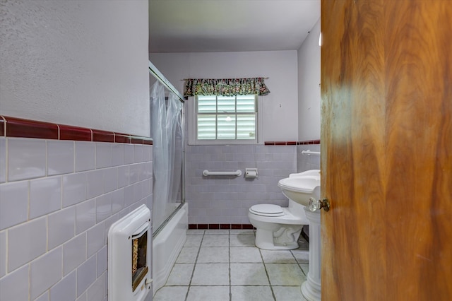 bathroom with tile walls, tile patterned floors, shower / bathtub combination with curtain, and toilet