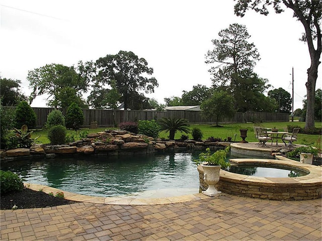 view of swimming pool with an in ground hot tub and a patio area