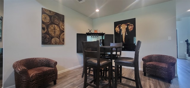 dining space with wood-type flooring