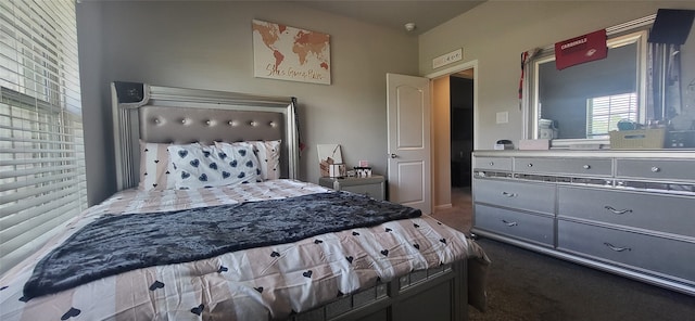 bedroom with dark colored carpet