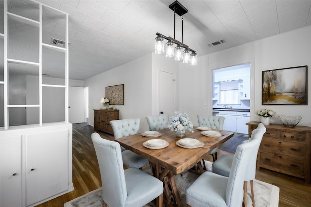 dining room with sink and dark hardwood / wood-style flooring