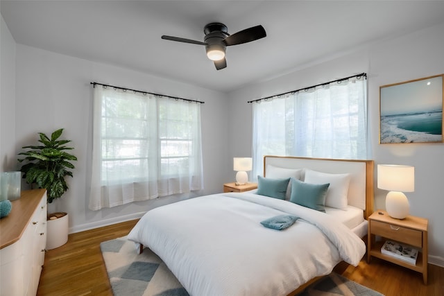 bedroom with ceiling fan and light hardwood / wood-style flooring