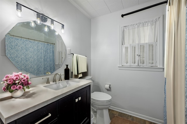 bathroom with hardwood / wood-style floors, crown molding, toilet, and vanity