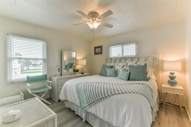 bedroom with light wood finished floors and a ceiling fan