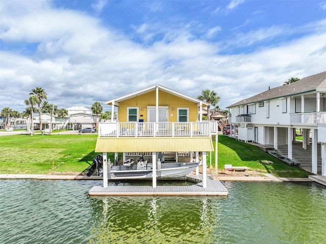 back of house featuring a water view, boat lift, a residential view, and a yard