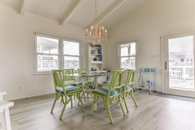 dining room with a notable chandelier, vaulted ceiling with beams, and wood finished floors