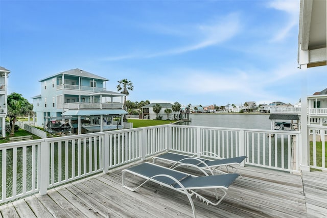 wooden terrace featuring a water view