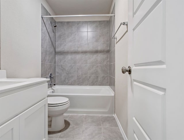 full bathroom with tile patterned floors, toilet, tiled shower / bath, and vanity