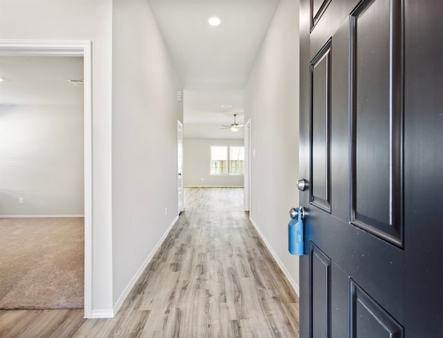 hallway featuring light carpet