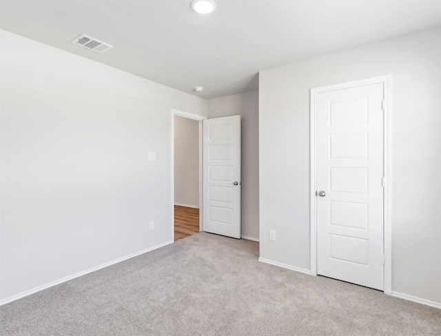 unfurnished bedroom featuring light carpet