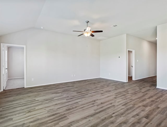 spare room with ceiling fan, wood-type flooring, and lofted ceiling