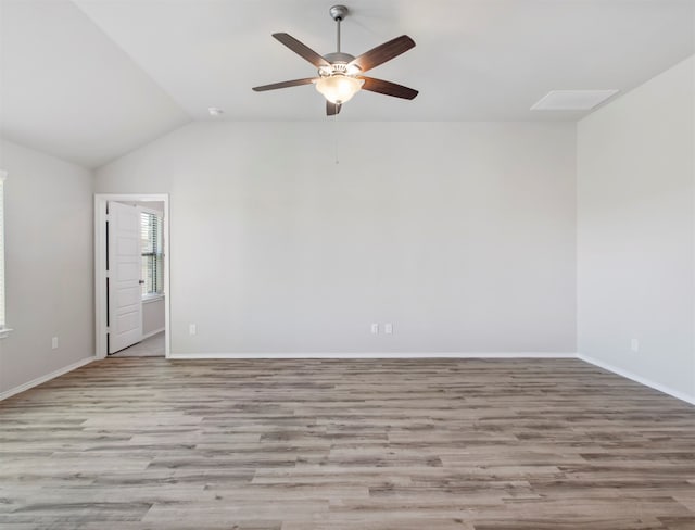 empty room with light wood-type flooring, vaulted ceiling, and ceiling fan