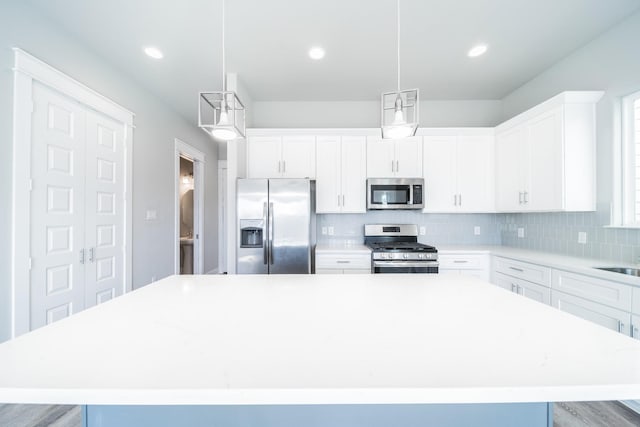 kitchen featuring backsplash, a center island, pendant lighting, and stainless steel appliances