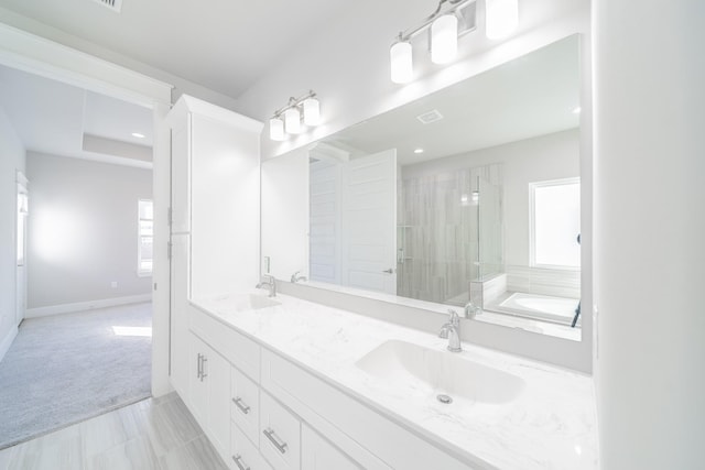 bathroom with tile patterned flooring, vanity, and independent shower and bath