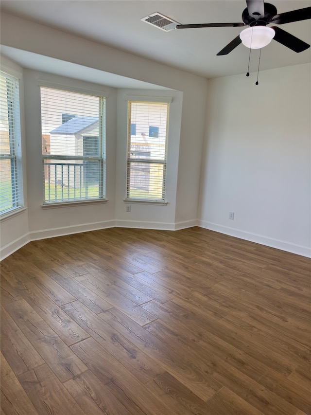 empty room featuring ceiling fan and dark hardwood / wood-style floors