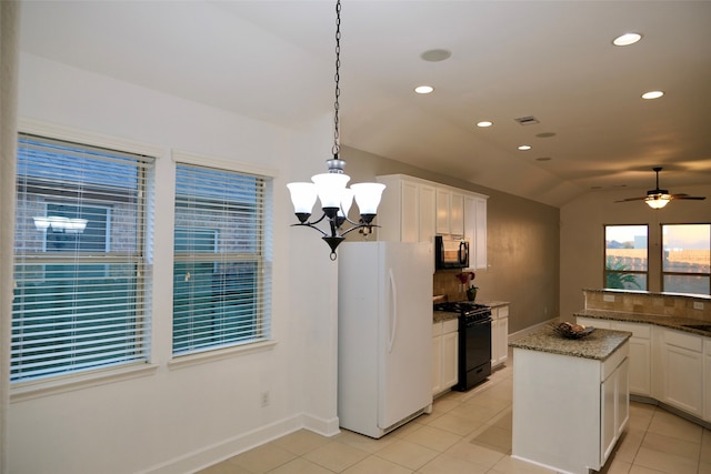 kitchen featuring white cabinets, pendant lighting, black appliances, and lofted ceiling