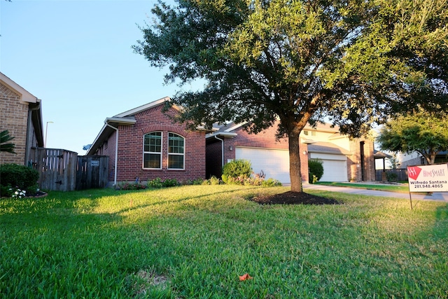 ranch-style home featuring a garage and a front lawn