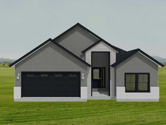 view of front of home with a garage and a front lawn