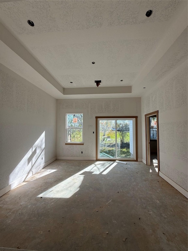 unfurnished room featuring a tray ceiling