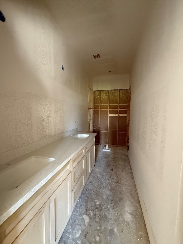 bathroom featuring sink and concrete floors