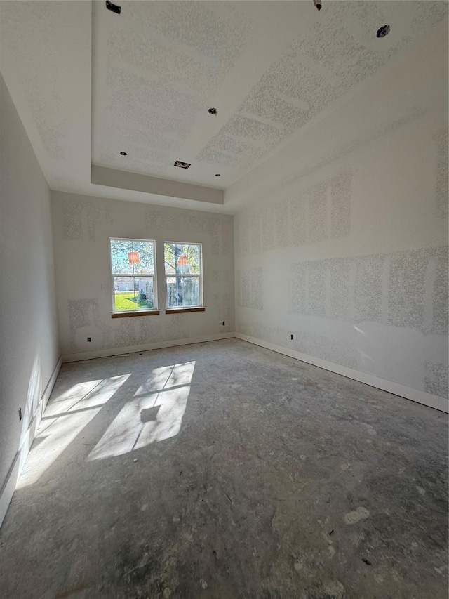 empty room featuring a tray ceiling