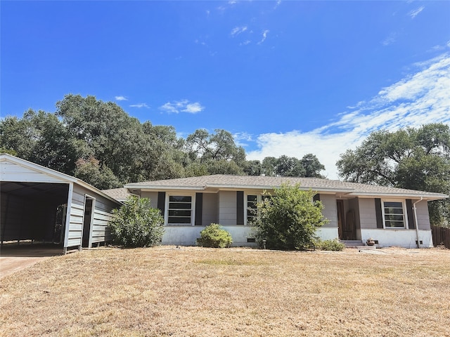 ranch-style house with a carport and a front lawn