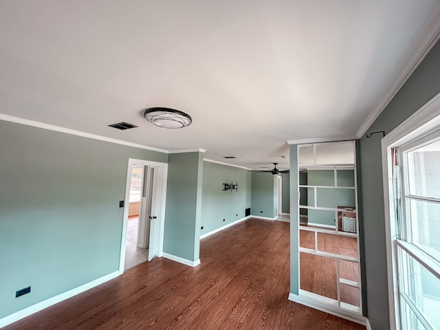 unfurnished room with hardwood / wood-style flooring, ceiling fan, a healthy amount of sunlight, and ornamental molding