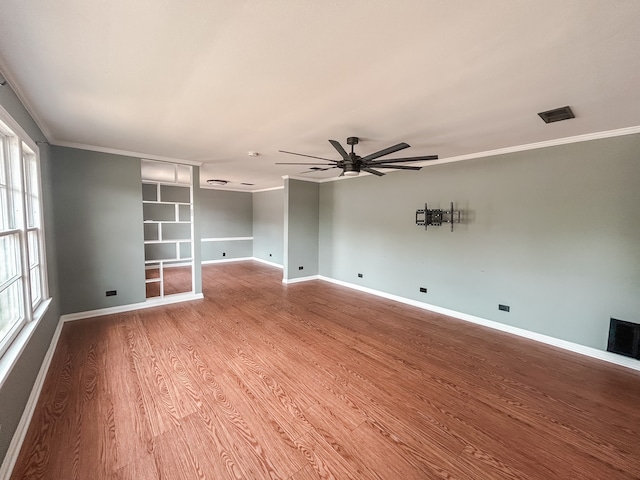 spare room featuring light wood-type flooring, crown molding, and ceiling fan