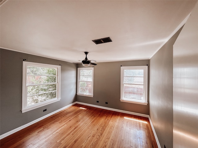 spare room with ceiling fan, crown molding, and hardwood / wood-style flooring