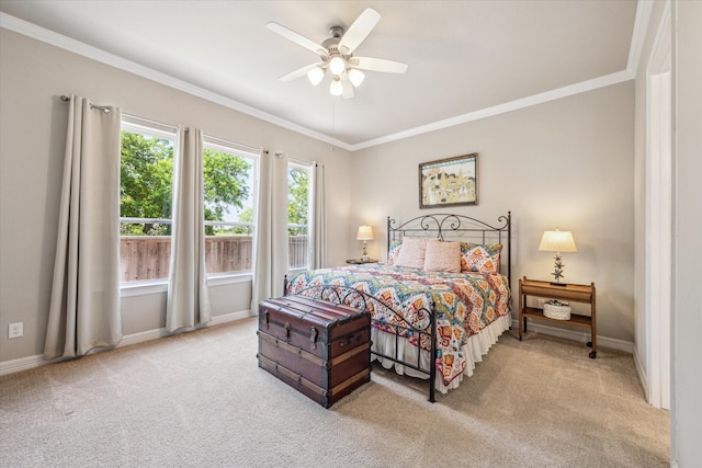 carpeted bedroom featuring ceiling fan and crown molding