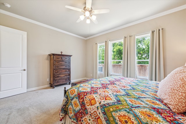 carpeted bedroom featuring ceiling fan and ornamental molding