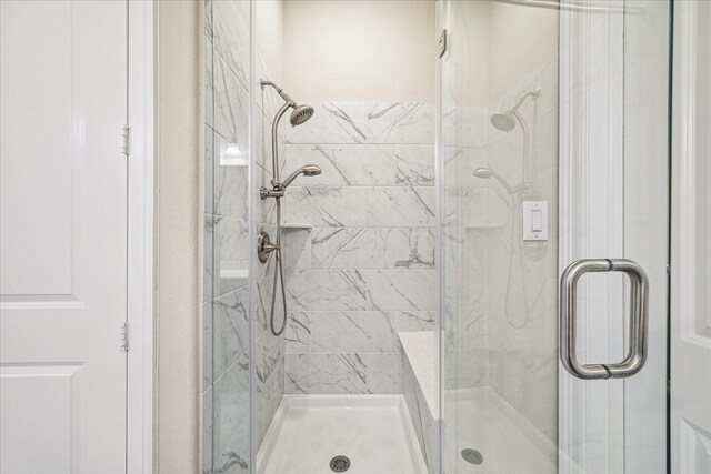 bathroom with a shower with shower door