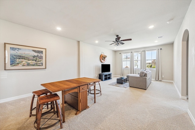 living room with light colored carpet and ceiling fan