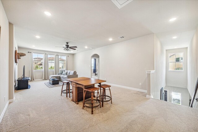 carpeted dining space featuring ceiling fan