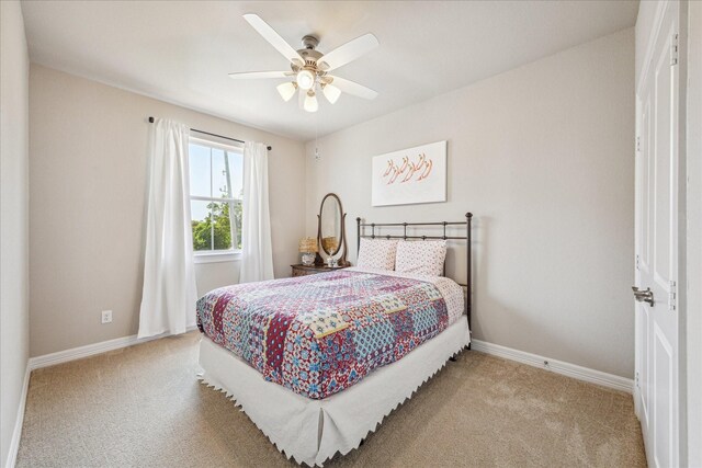 bedroom featuring ceiling fan and light carpet