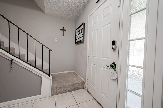 tiled entrance foyer with plenty of natural light and a textured ceiling