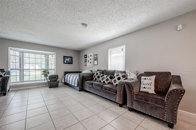 bedroom with light tile patterned floors and a textured ceiling