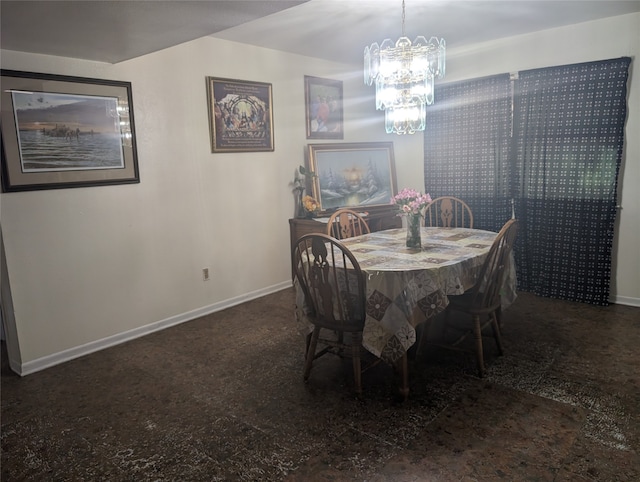 dining room featuring dark tile patterned flooring and a chandelier