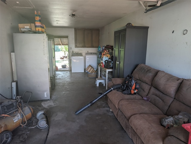 living room with washing machine and dryer and concrete flooring