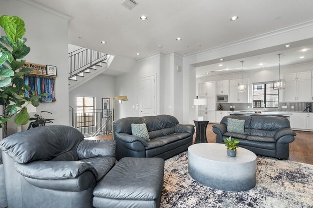 living room featuring hardwood / wood-style floors, a wealth of natural light, and ornamental molding