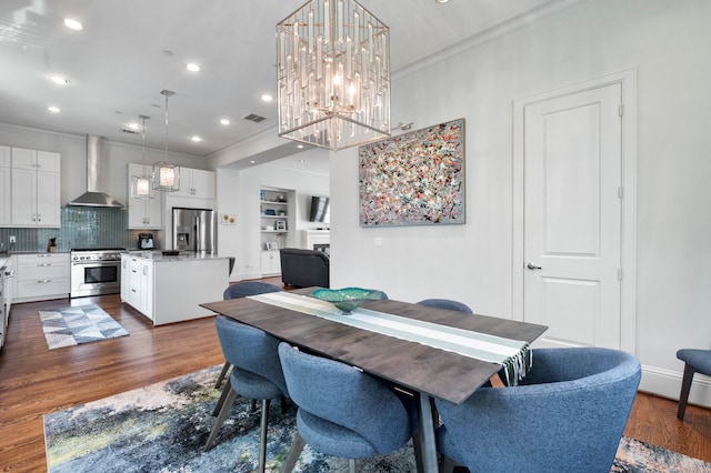 dining room featuring ornamental molding, dark hardwood / wood-style floors, and built in shelves